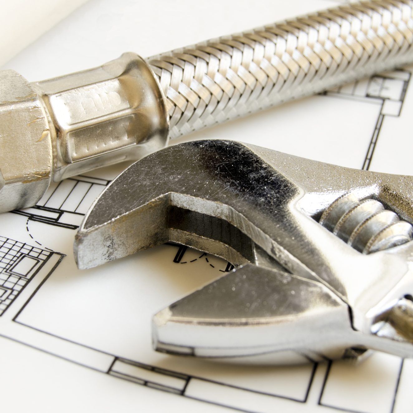 Plumbing tools on house blueprint
